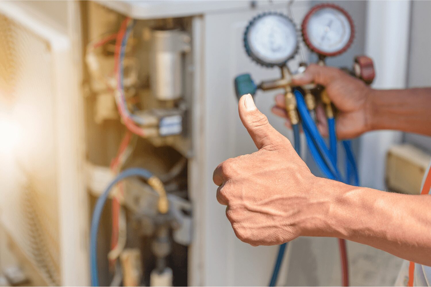 A person giving thumbs up next to an air conditioner.